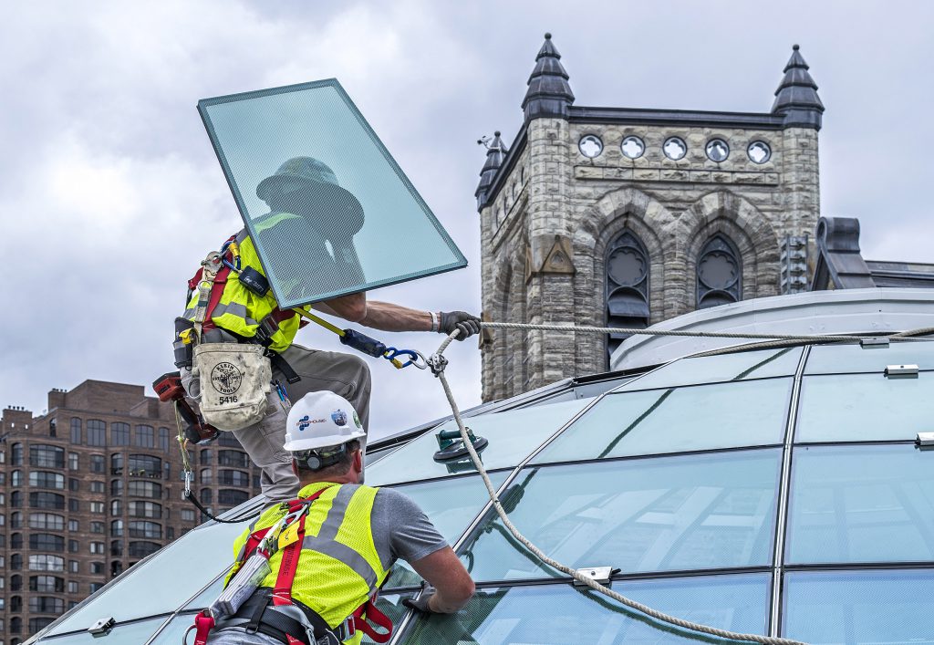 construction workers installing glass project