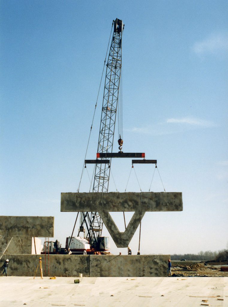 concrete wall being lifter by crane