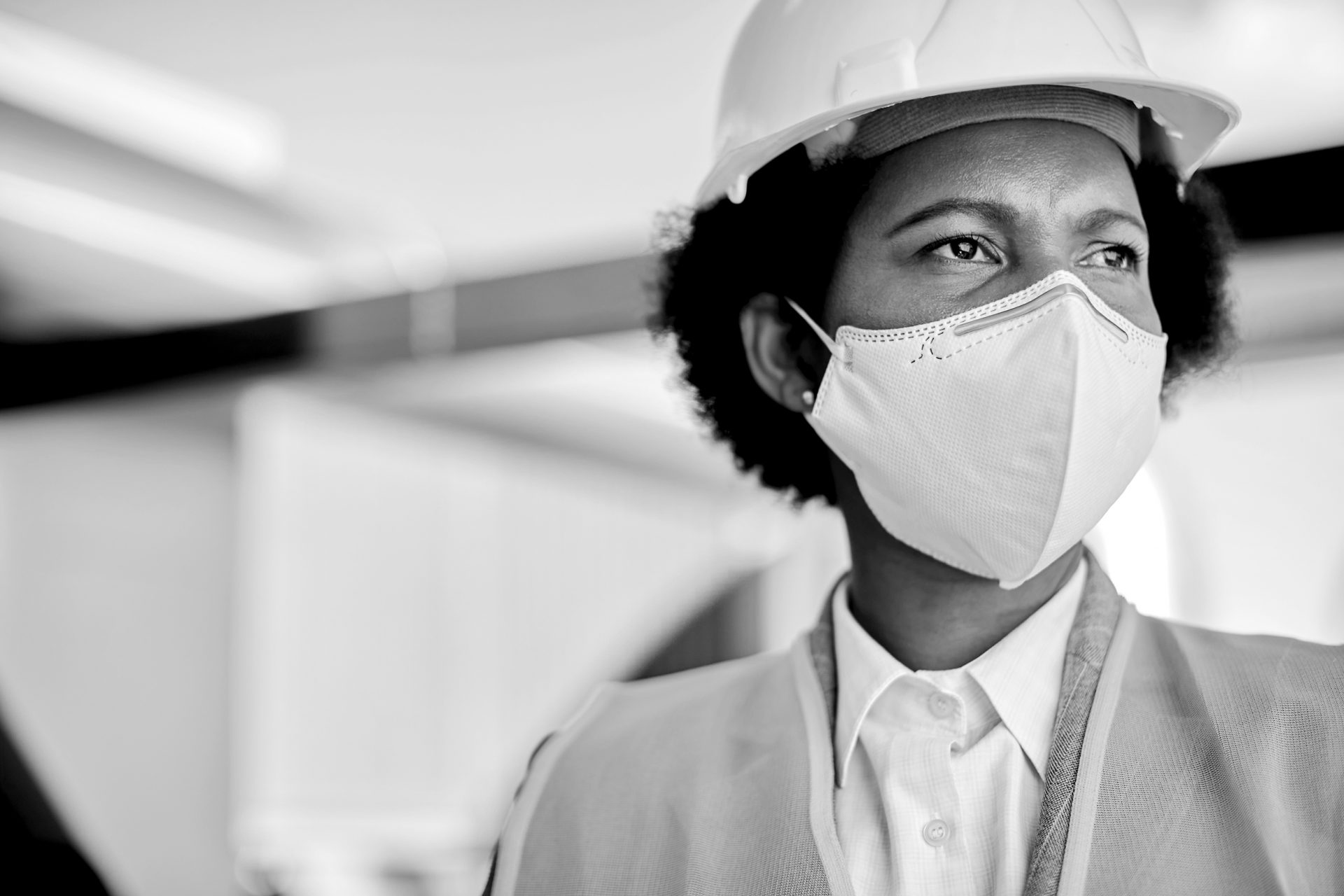 female construction worker wearing PPE mask