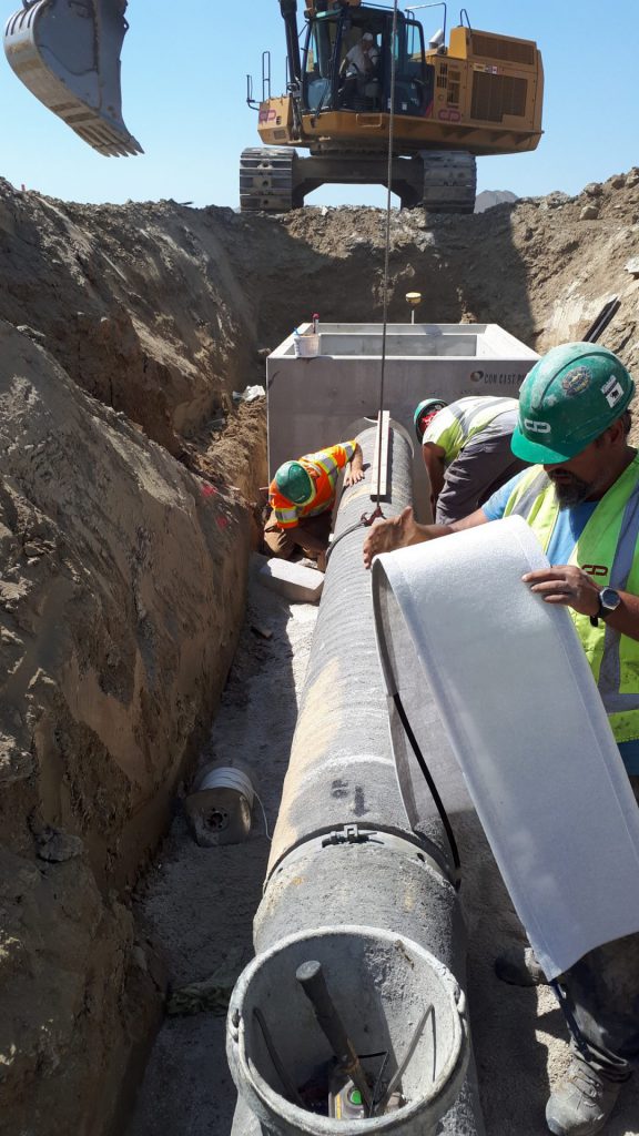 Forterra construction workers installing concrete pipe underground
