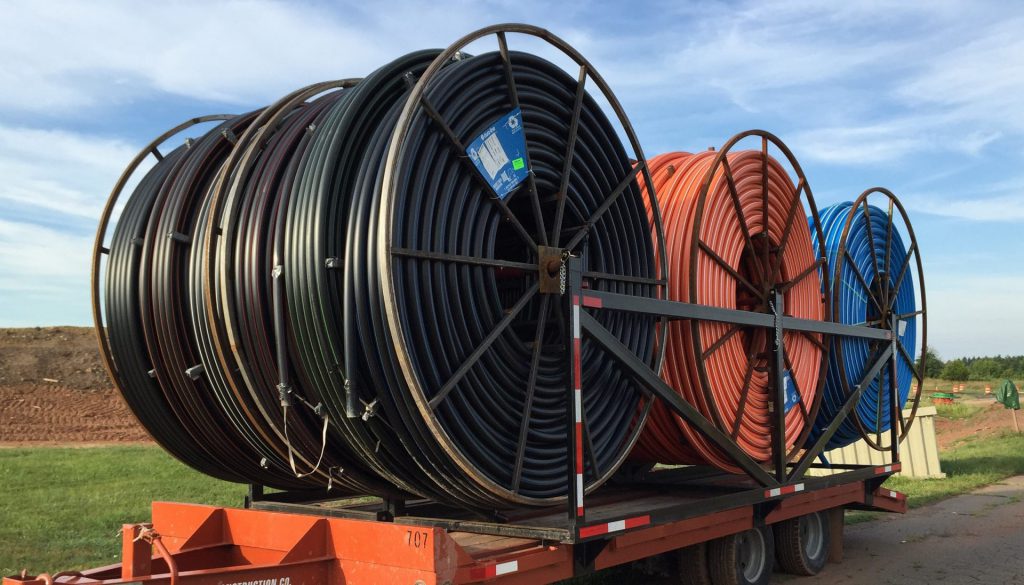 large reels of plastic pipe for PPI installation on truck bed