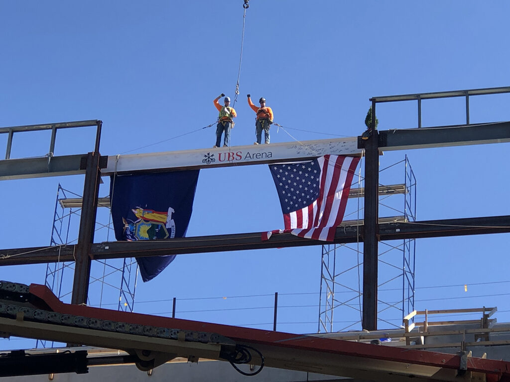 JC Steel workers standing on steel beam