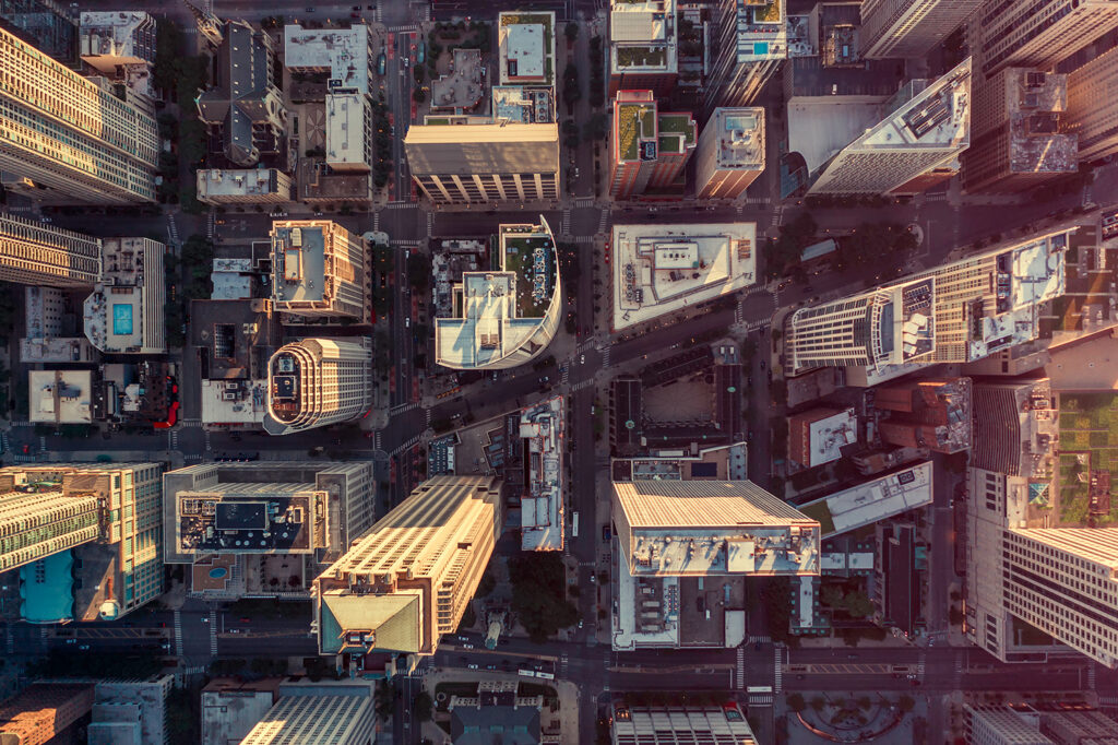 aerial view of buildings in city at sunset