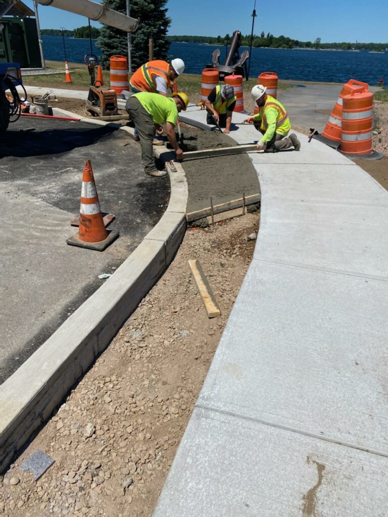 luck bros working on sidewalk paving