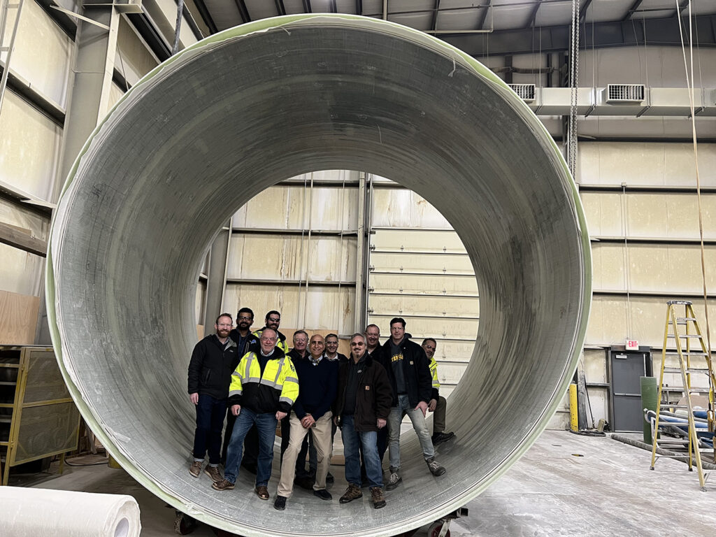 quakewrap team inside large precast pipe