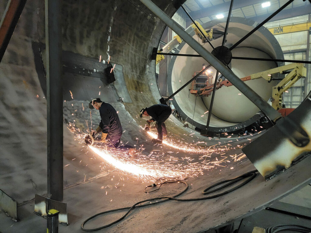 MIW team welding inside large cylinder