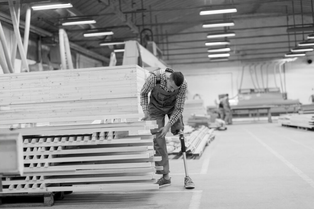 man with physical disability working in a lumber warehouse