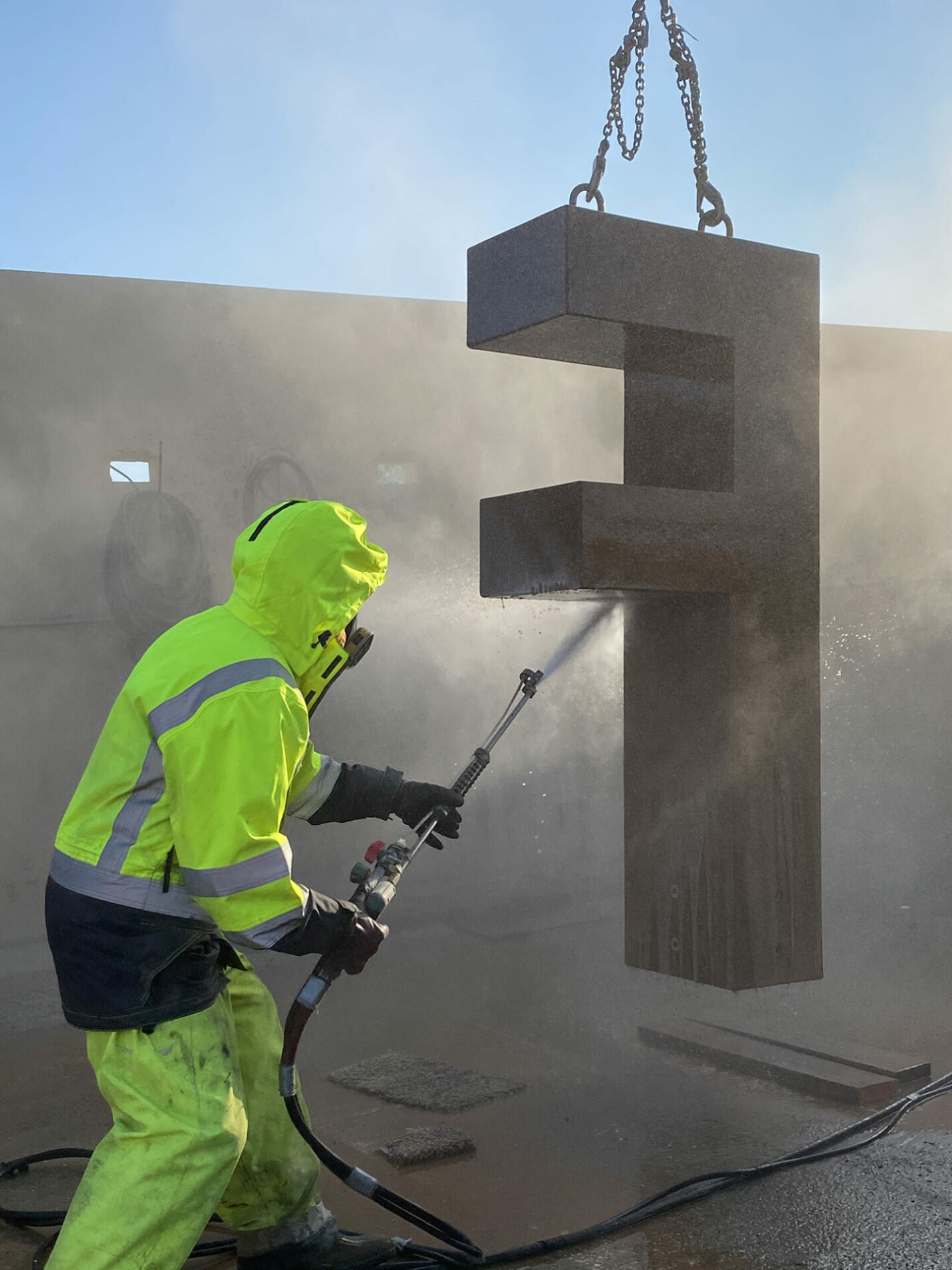 Precast Unlimited finishing a giant concrete "F"