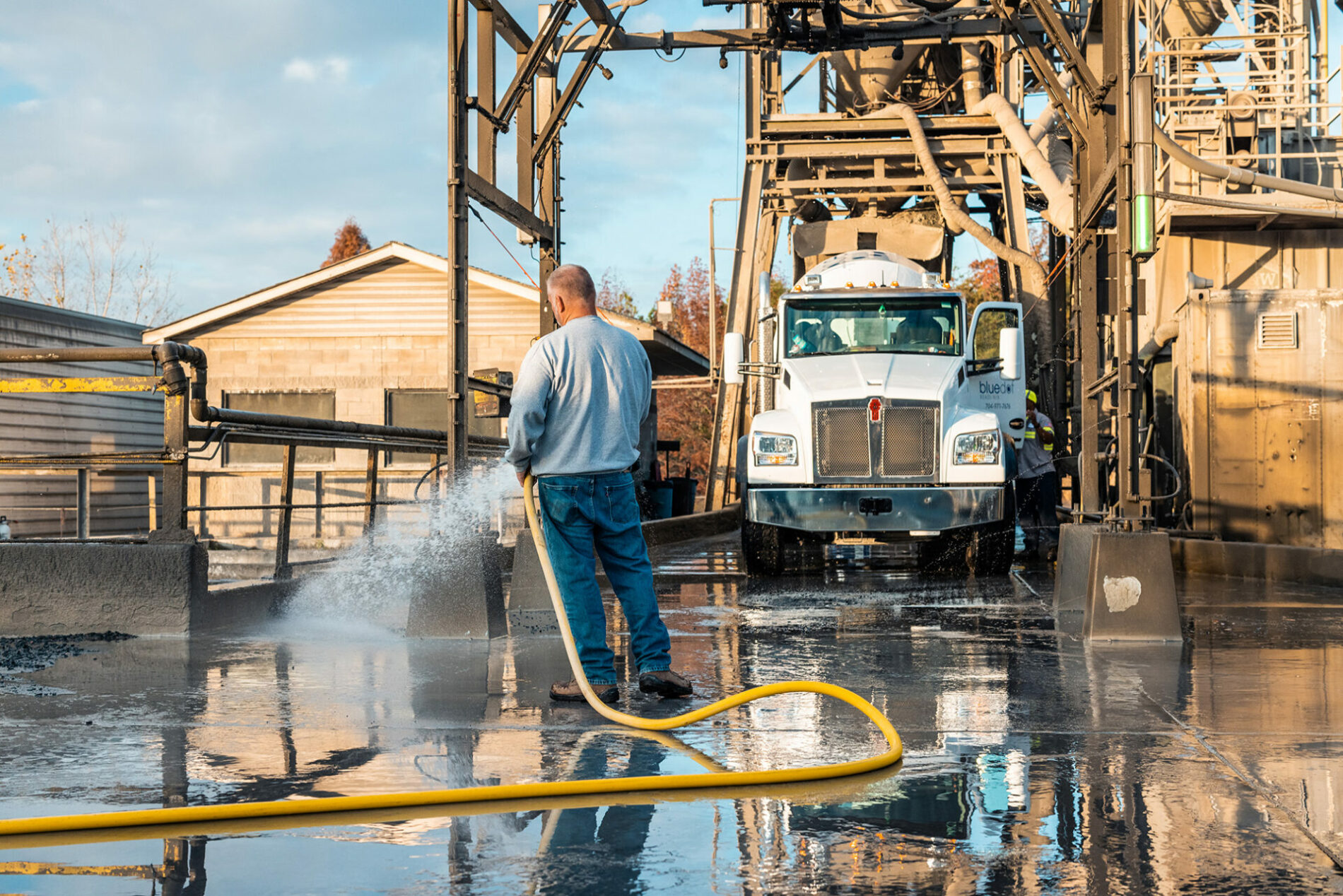 Blue Dot Readi-Mix truck being sprayed down and cleaned