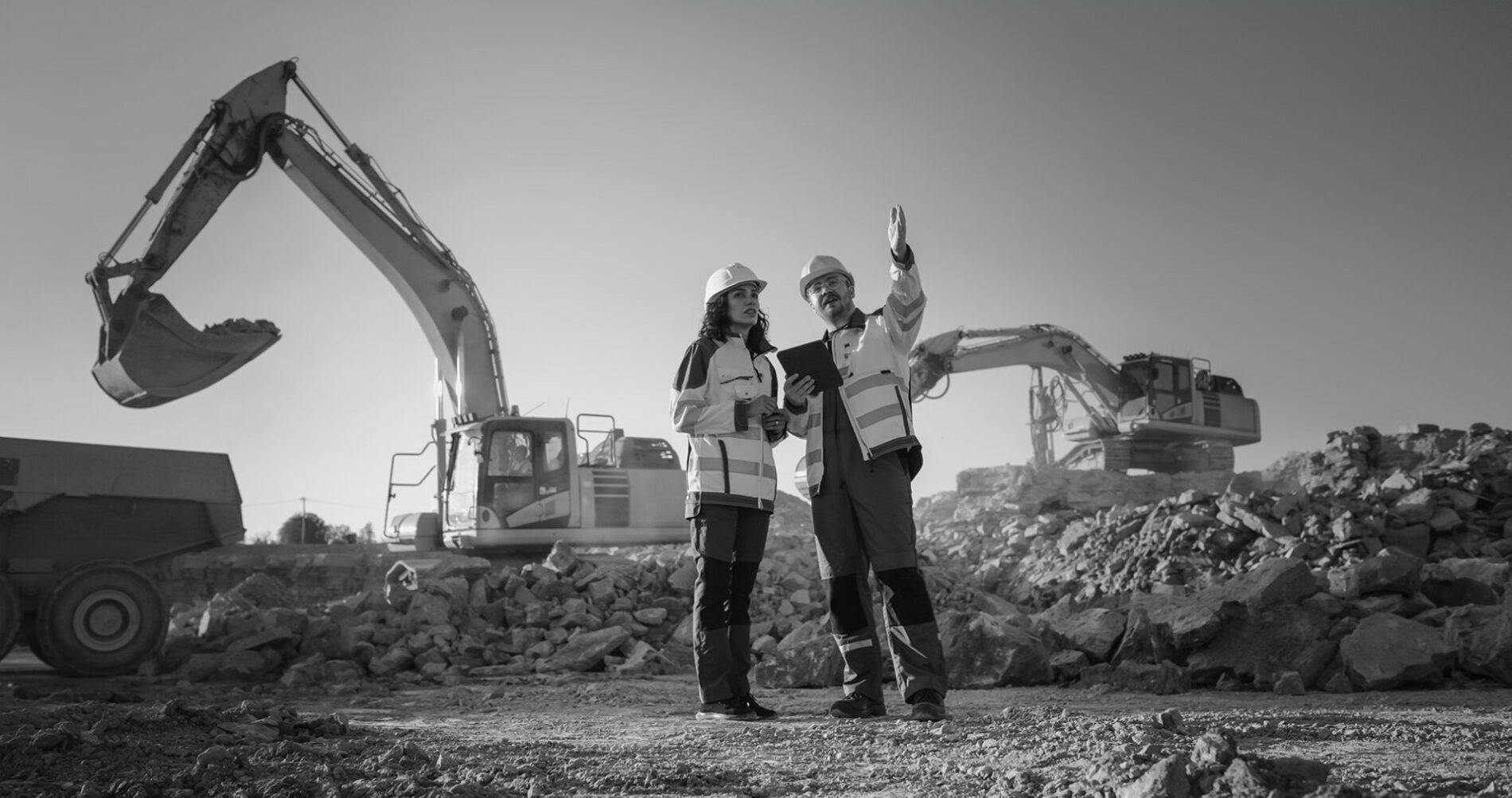 two construction workers discussing economic impact of build