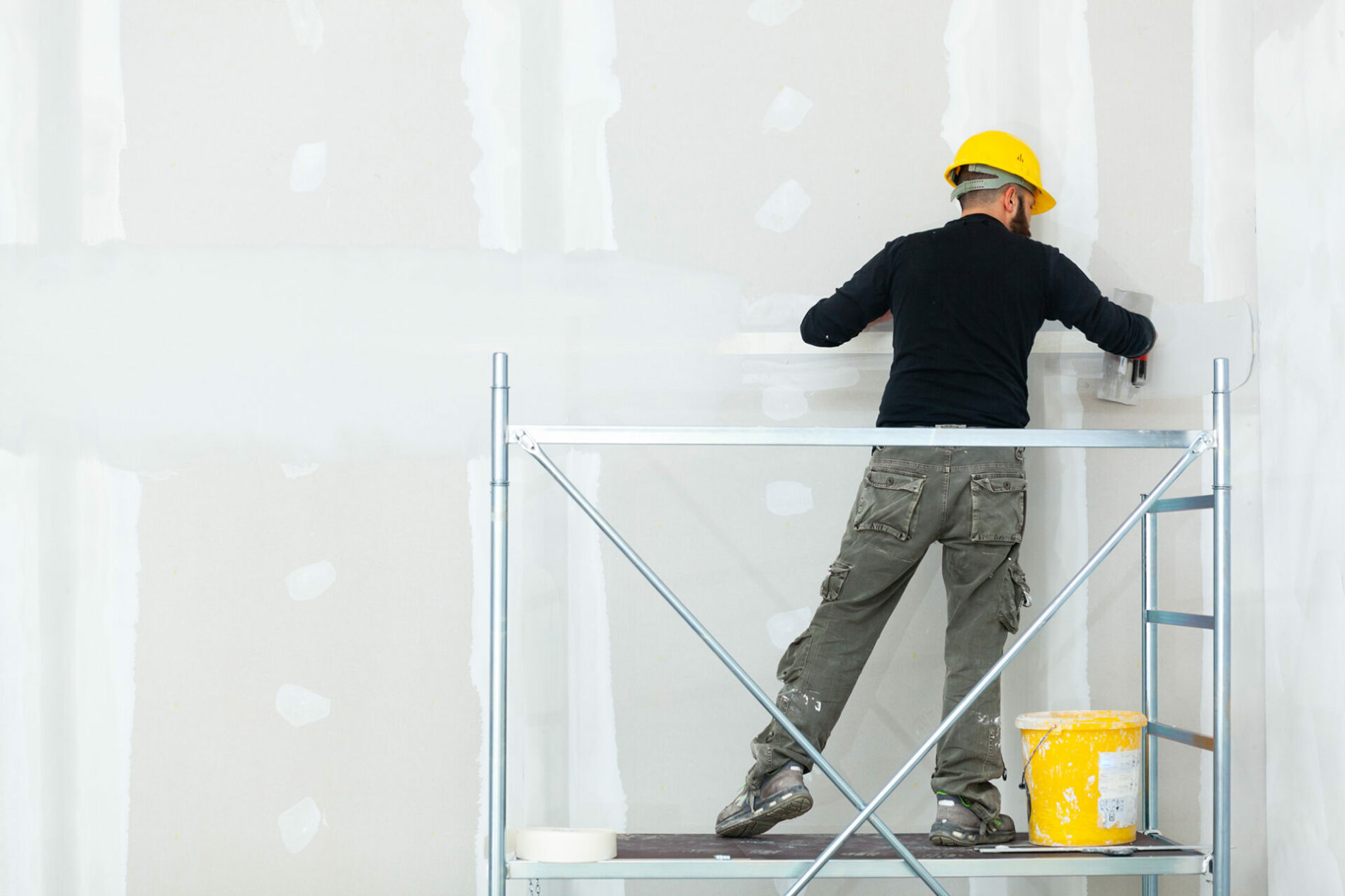 L.I.C Builders worker installing GWB walls