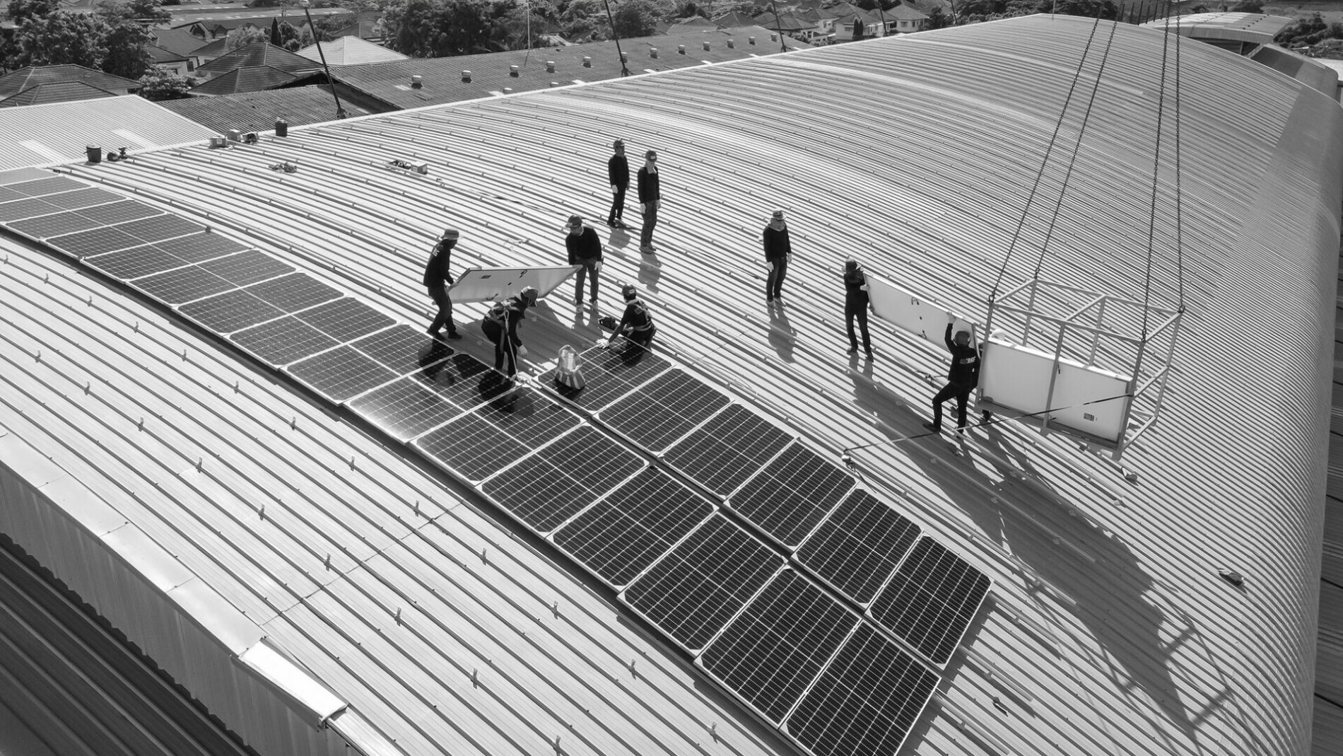 solar panels being installed on building roof to create renewable energy