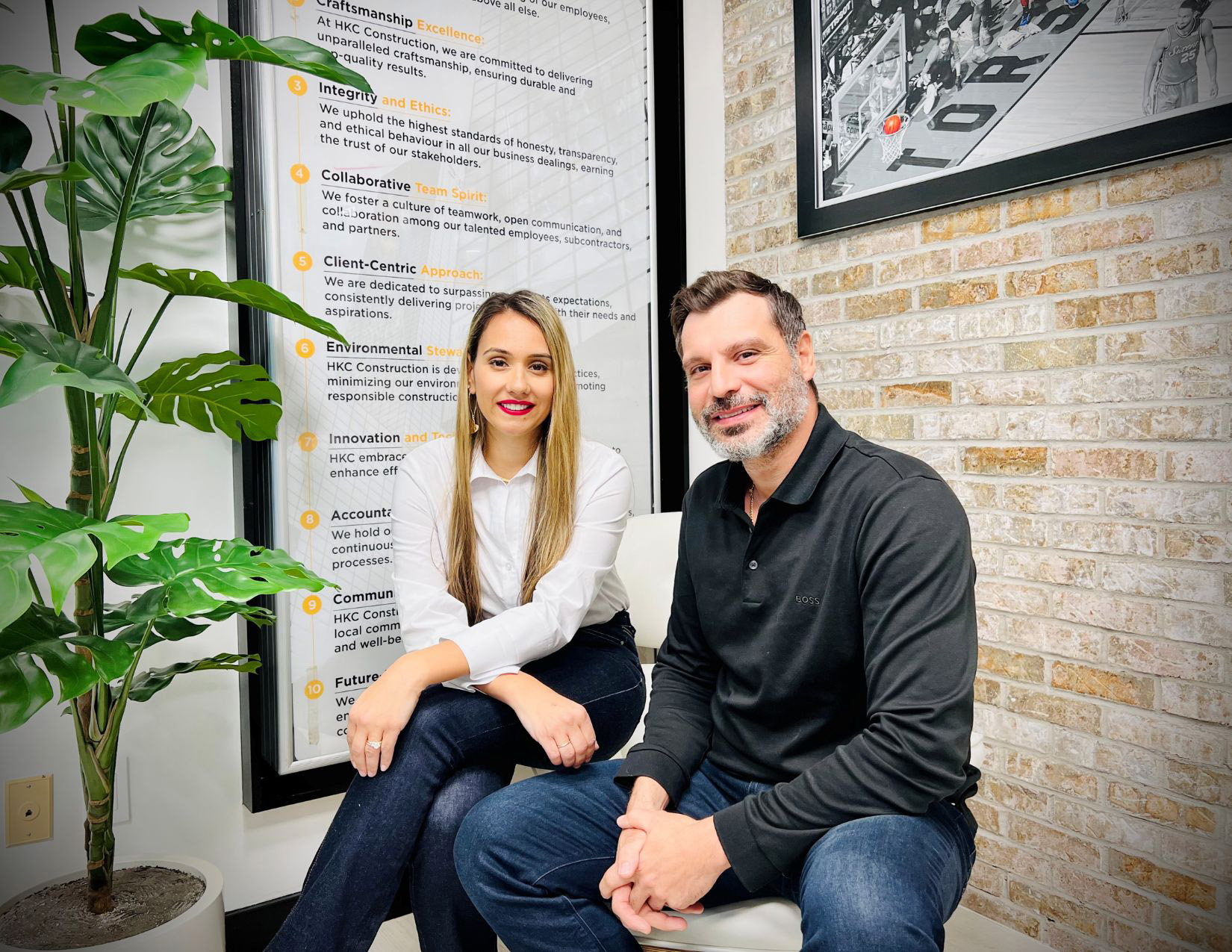 Two co-owners sitting next to each other in office.