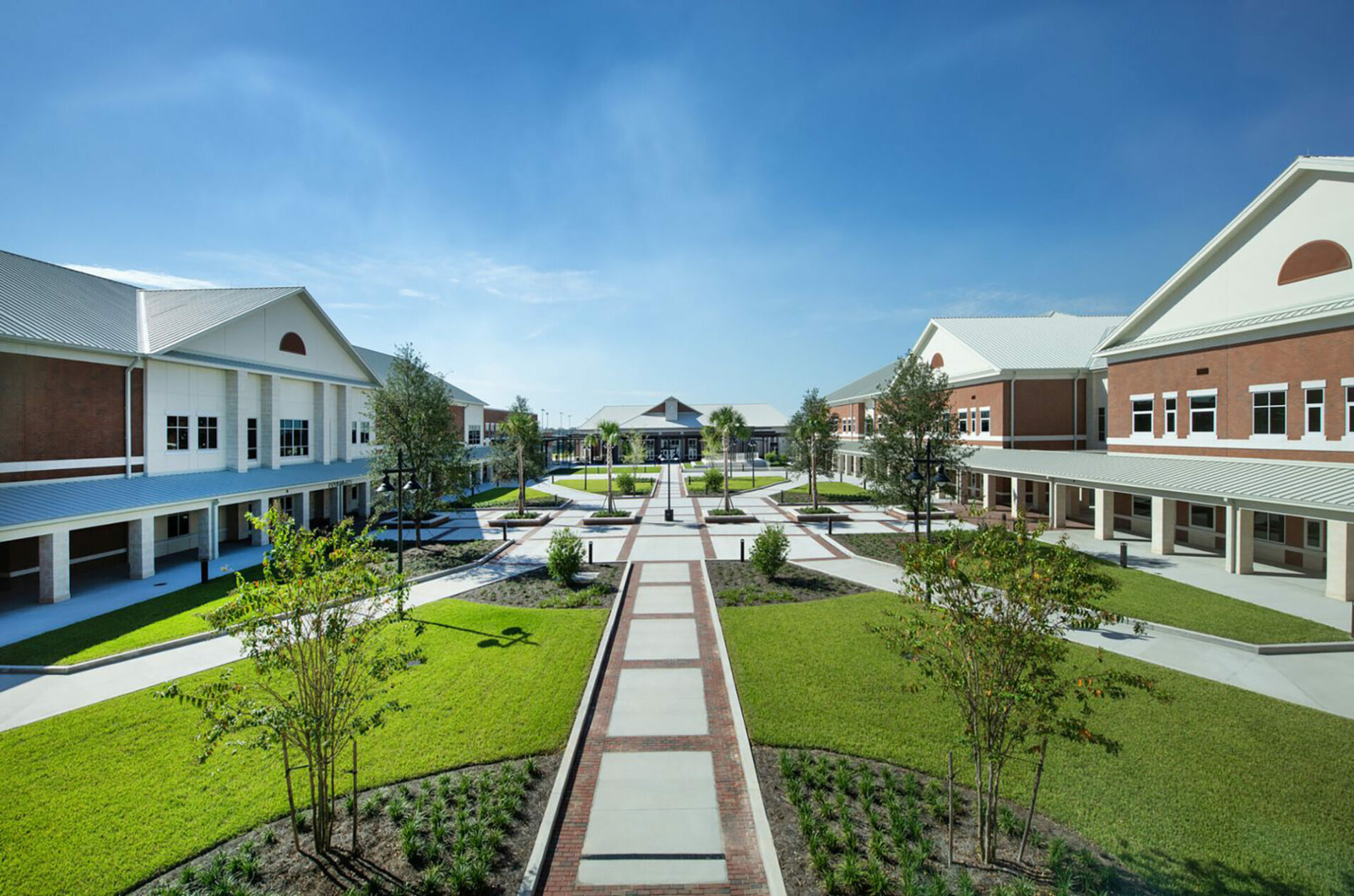 A photo of a village area courtyard with school buildings.