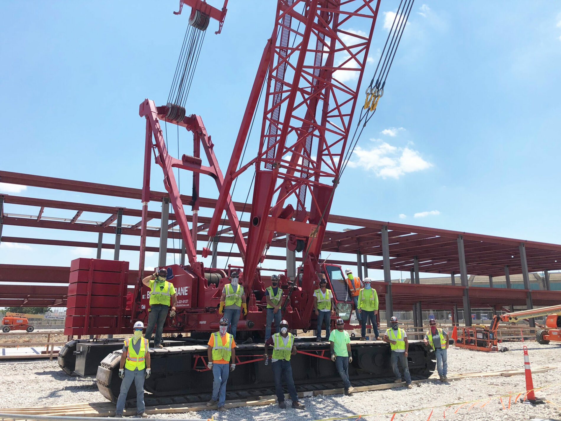 A photo of a steel construction site with group of people standing together.