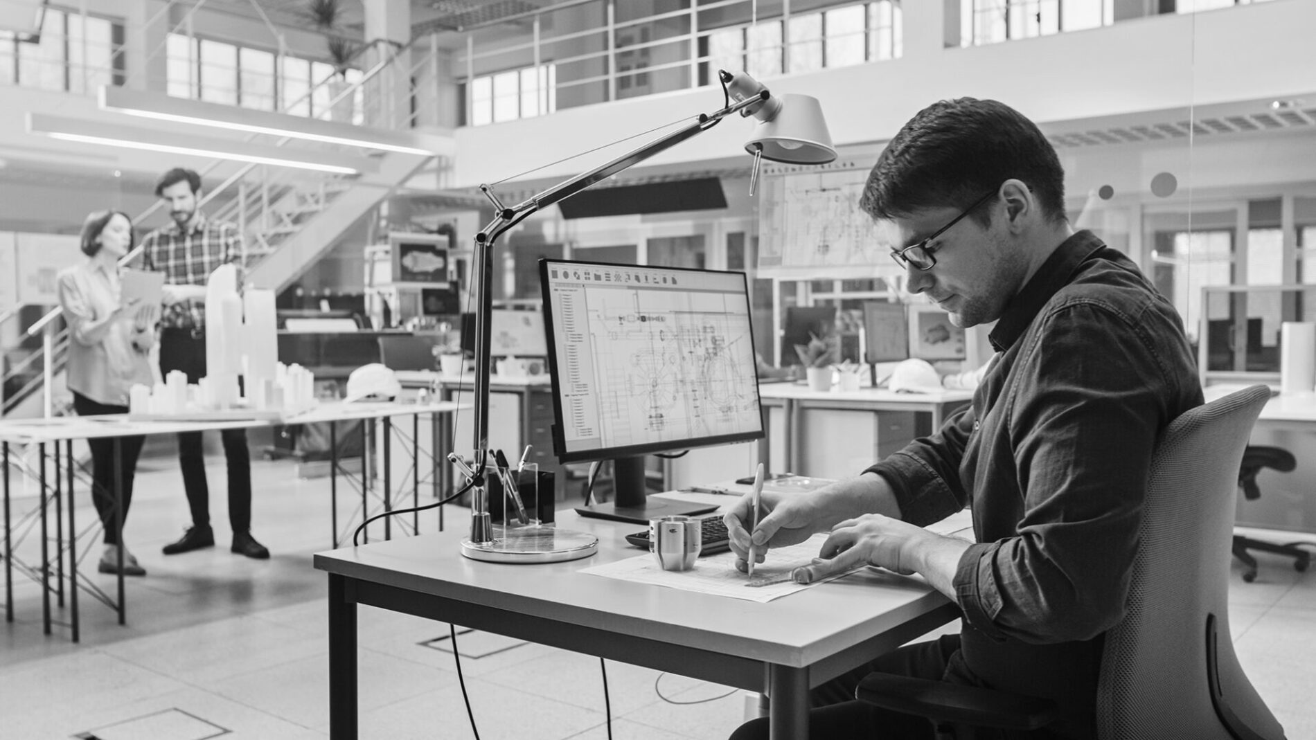 In Architectural Bureau: Team of Architects and Engineers Working on a Building Complex Prototype Project, Using City Model and Computers Running 3D CAD Software. Residential or Business District