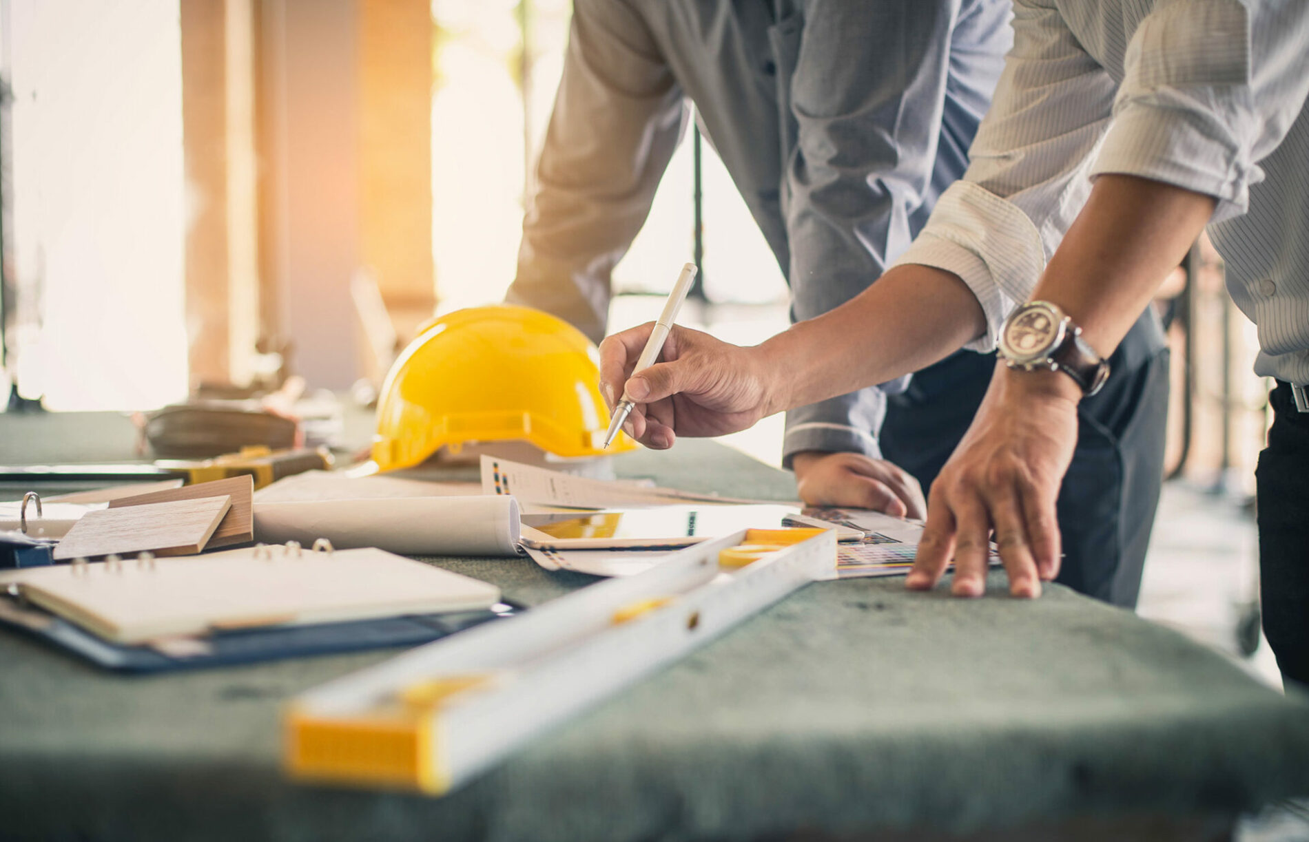 Two business man construction site engineer. Engineering objects on workplace with partners interacting on background