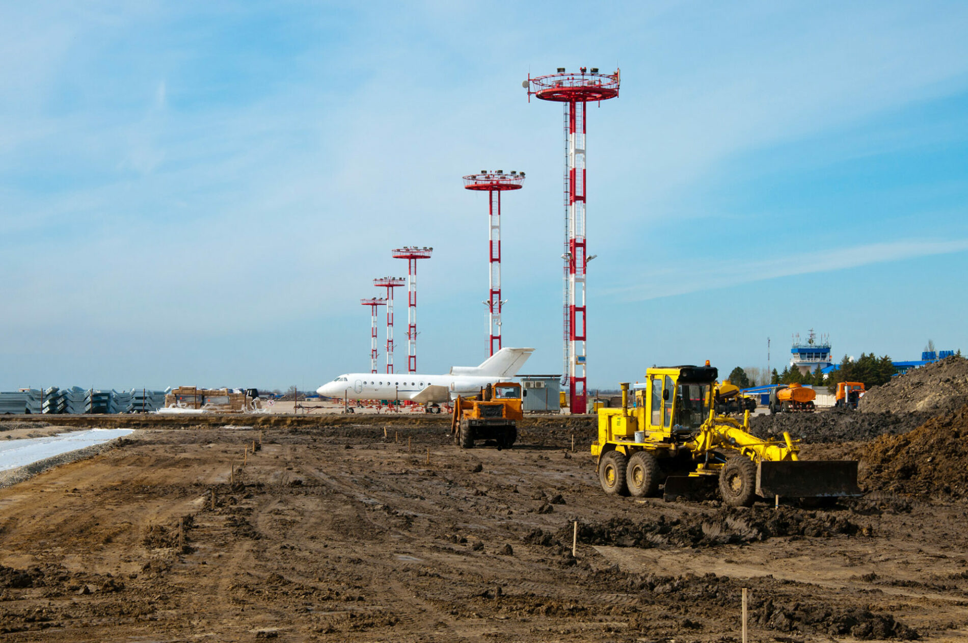 Grader and aircraft at reconstruction airfield.