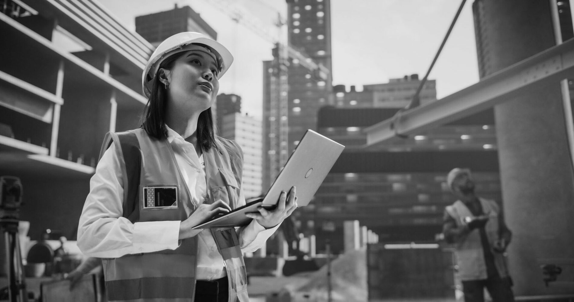 Asian Female Architect Working as a Civil Engineer. Young Japanese Woman Using Computer Software for Planning, Designing and Constructing a Commercial Real Estate Building in the Heart of the City